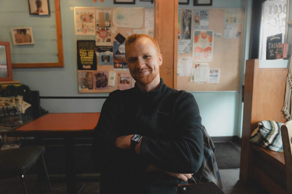 Esau Weddings owner, Connor, sitting at a coffee shop