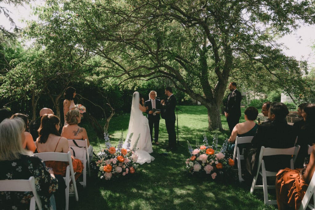 Wedding ceremony under the overhanging tree at Rouge Restaurant