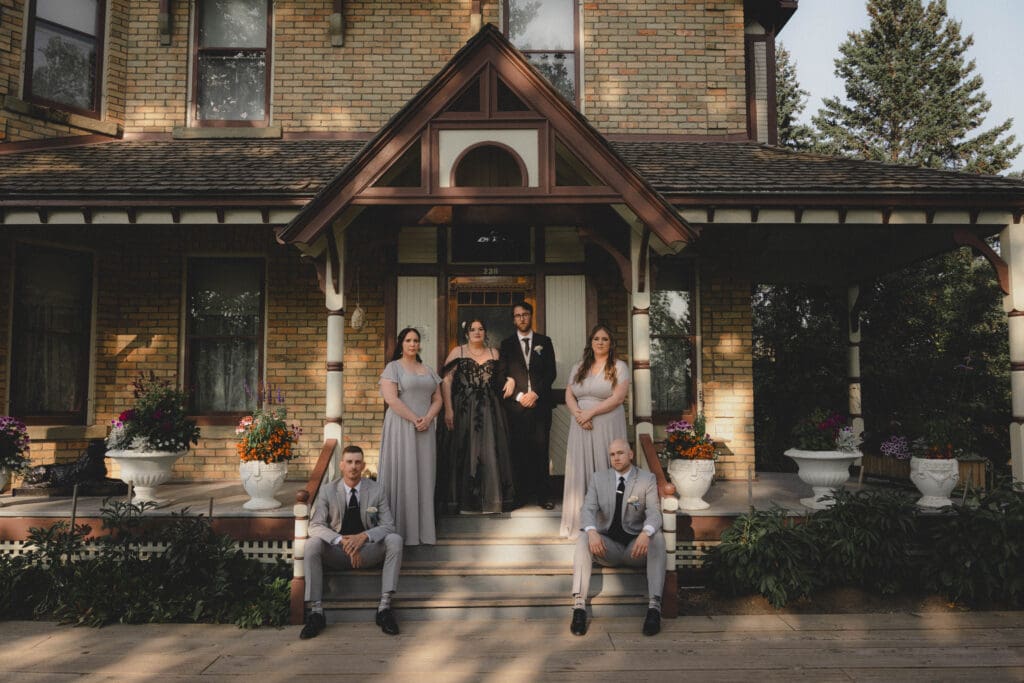 Wedding Party standing in front of an old building at Heritage Park Wedding Venue