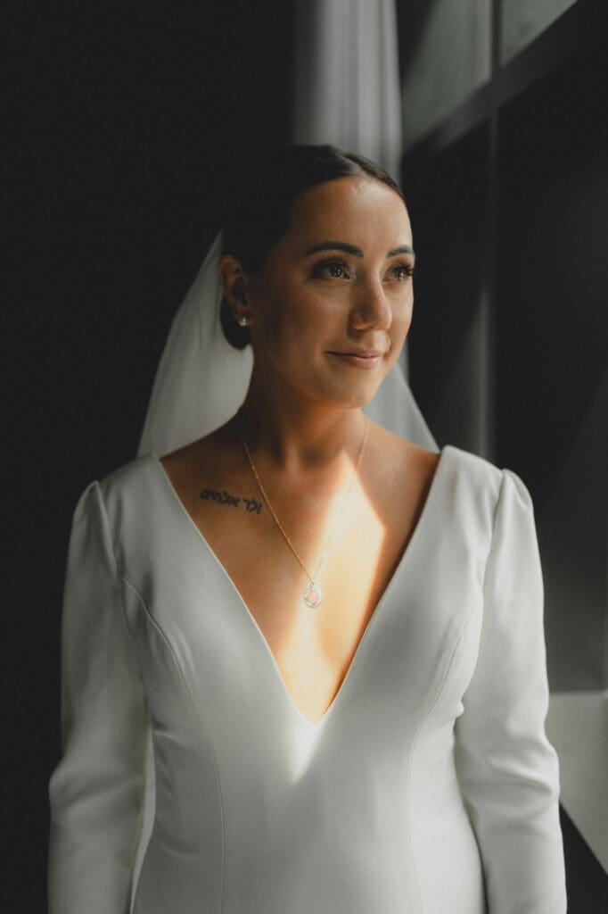 Bride looking out the window at a hotel