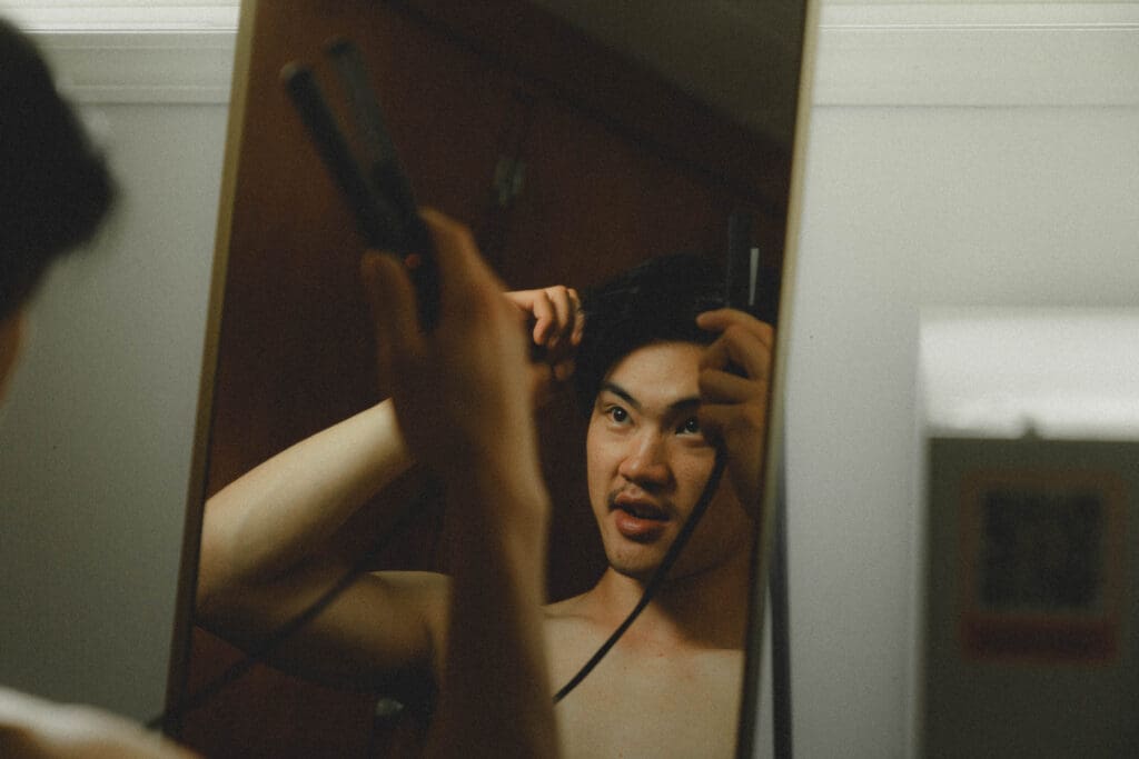 Groom fixing his hair in the morning of his Drumheller Wedding