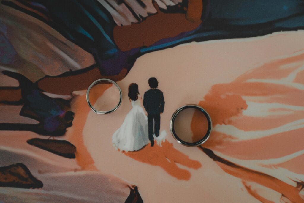 Wedding Rings beside a painted Wedding couple in Drumheller