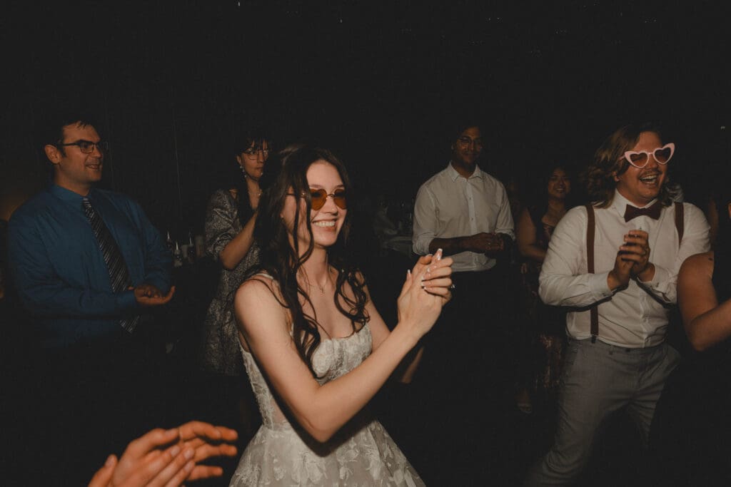 Bride clapping on the wedding dance floor