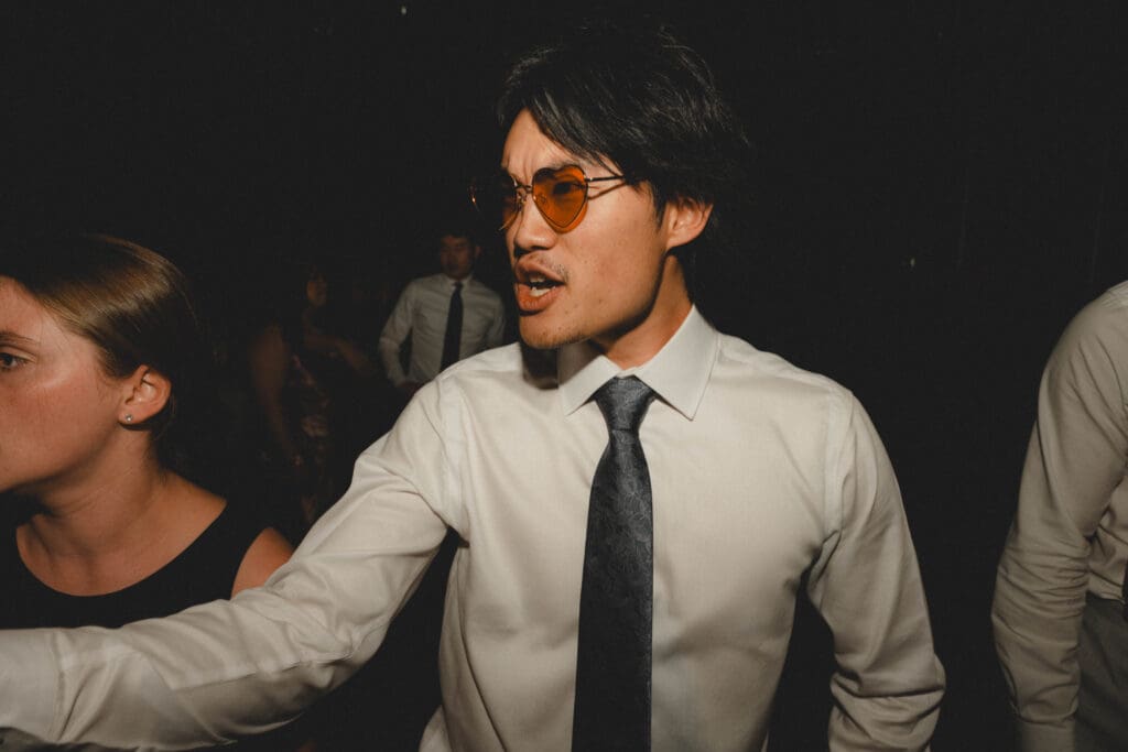 Groom making a silly face on the dance floor
