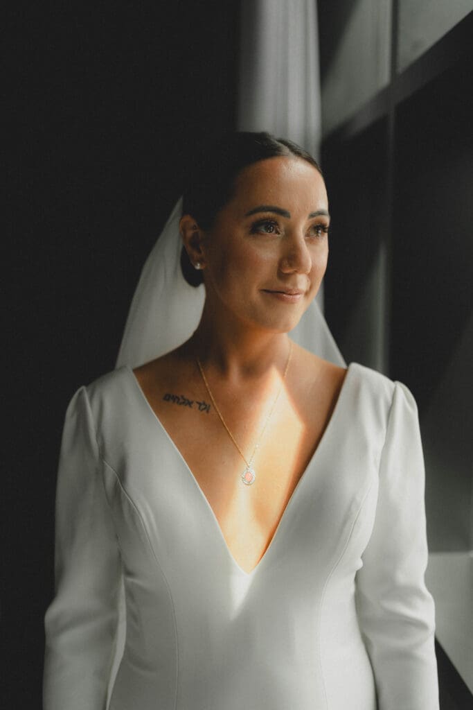 Bride looking out a window 
