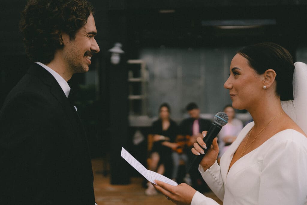 Bride reading vows during ceremony on Charbar's Rooftop Patio