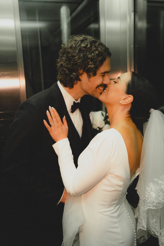 Wedding couple nearly kissing in Charbar's elevator