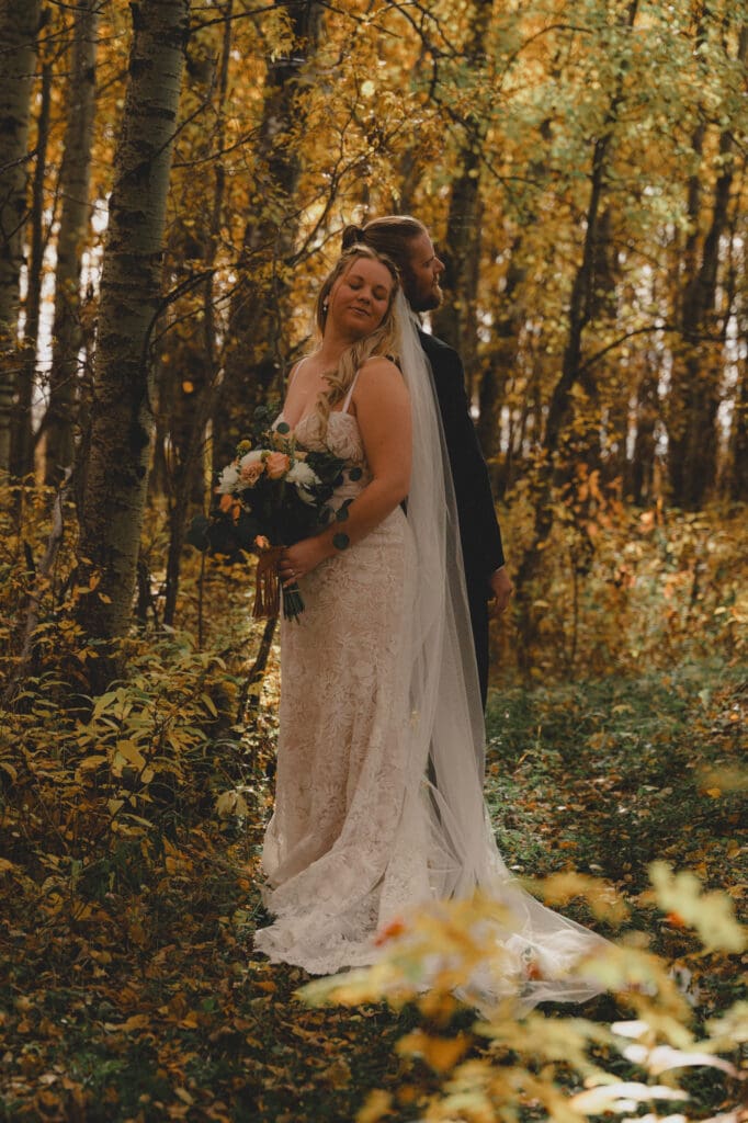 Wedding couple doing a first touch in the fall colours